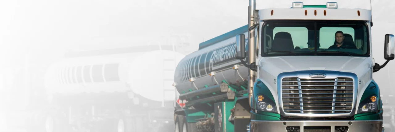 Rhinehart Oil fuel tanker with an employee in the cabin transporting fuel and lubricants.